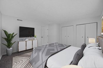 A bedroom with a large bed and a tv on the wall